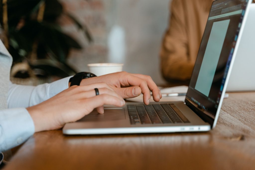 Person working on a laptop in a meeting.
